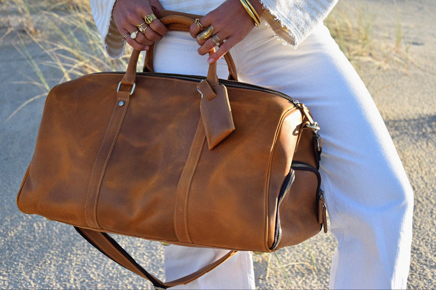 Close-up of COFFT DUFFLE 01 Latte leather weekend bag showing smooth tan leather, zipper and side pocket