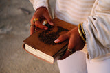 Close-up of COFFT leather notebook cover with embossed-style artwork and premium handmade texture
