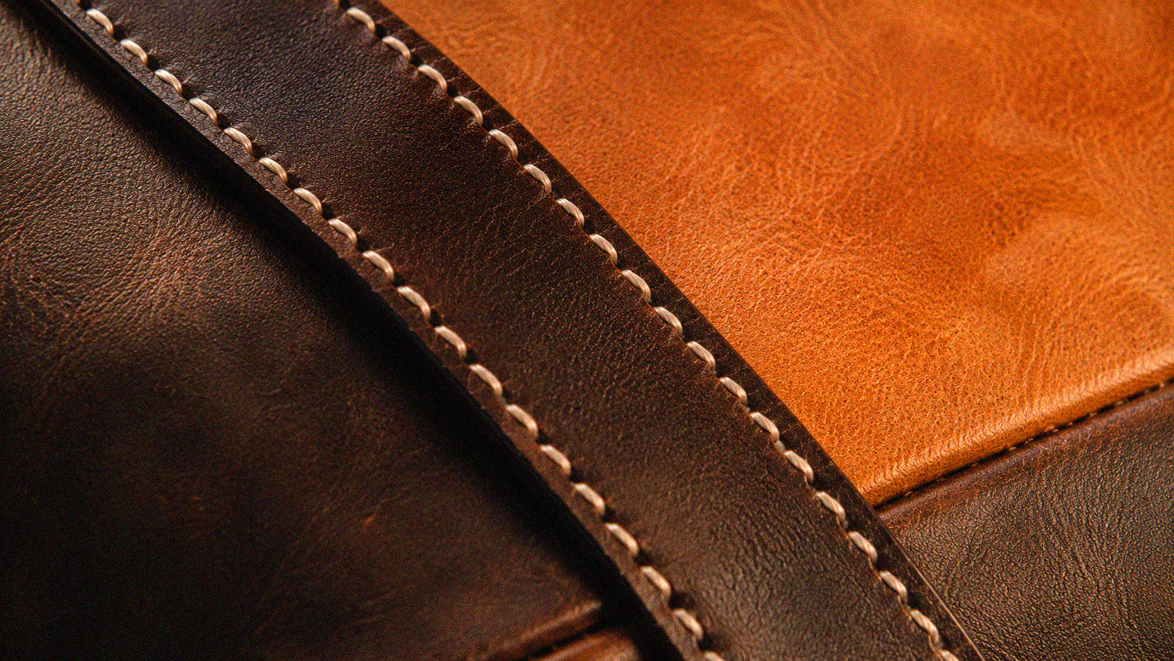 Close-up of COFFT leather texture and branded hardware