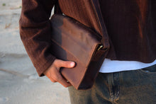 COFFT Espresso leather messenger bag worn crossbody with warm brown tones and structured flap design