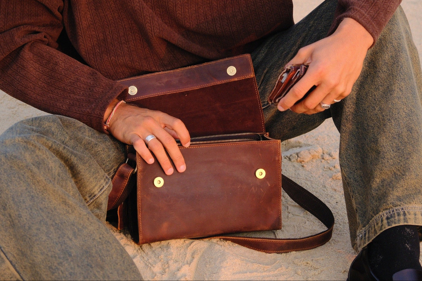 Open COFFT Espresso leather messenger bag showing interior compartment, zipper pocket and magnetic closure