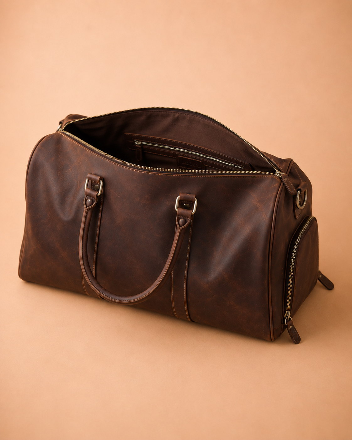 Open leather duffle bag packed for a short trip