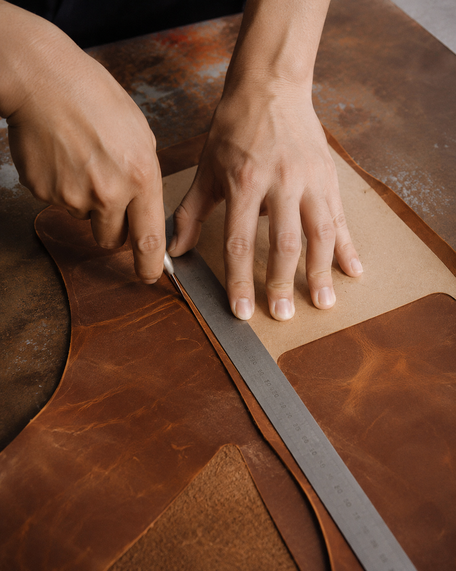 Leather being measured and cut by hand