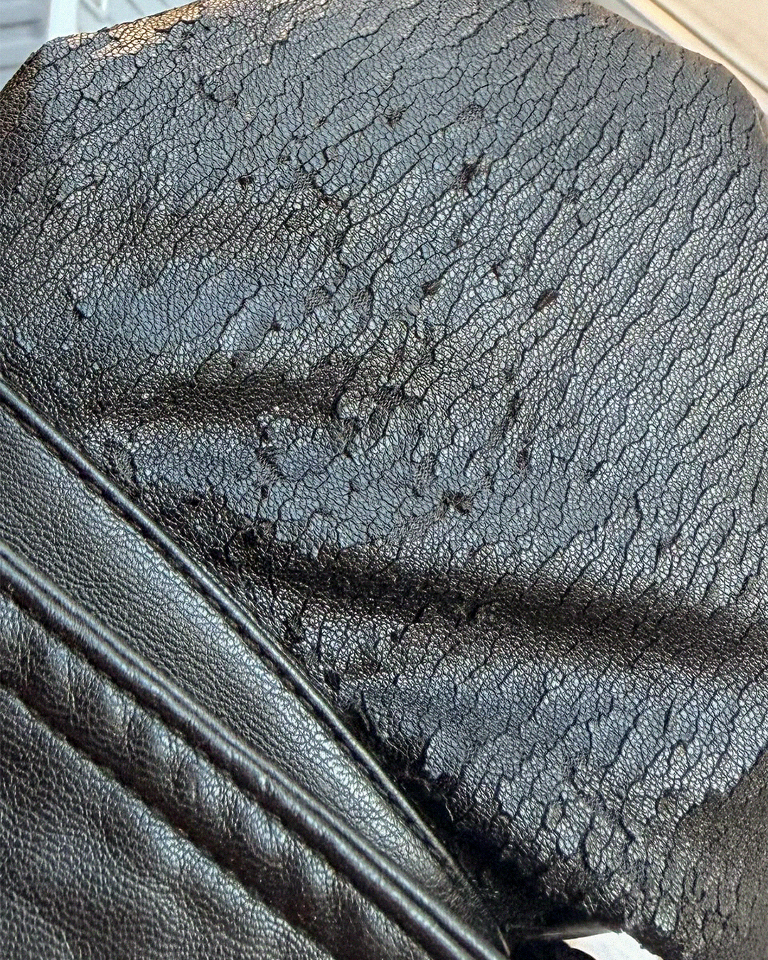 Close-up of cracked and peeling PU leather coating